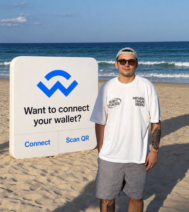 A man wearing sunglasses, a white 'Never Have Been' t-shirt, and a backwards cap stands on a sandy beach next to a large 3D-rendered graphic reading 'Want to connect your wallet?' with Connect and Scan QR buttons.