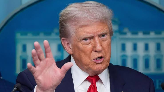 Former President Donald Trump gestures as the "21st Century ROAD to Housing Act" becomes law, banning a federal digital dollar until 2031 after he let the signing window expire. This image shows Trump, whose inaction led to the bill's passage and the prohibition on the Fed issuing a CBDC.