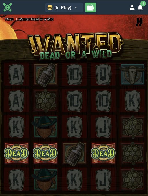 A screenshot from the "Wanted Dead or a Wild" slot game showing a grid of Western-themed symbols including playing cards, whiskey bottles, cowboy hats, and "DEAD" bonus symbols, capturing the moment before a potentially big win.