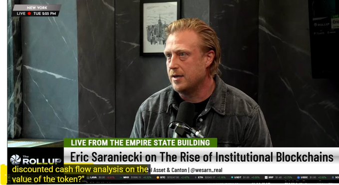A news broadcast screenshot featuring Eric Saraniecki discussing 'The Rise of Institutional Blockchains,' with the headline 'discounted cash flow analysis on the value of the token?' and labeled as 'LIVE FROM THE EMPIRE STATE BUILDING.'