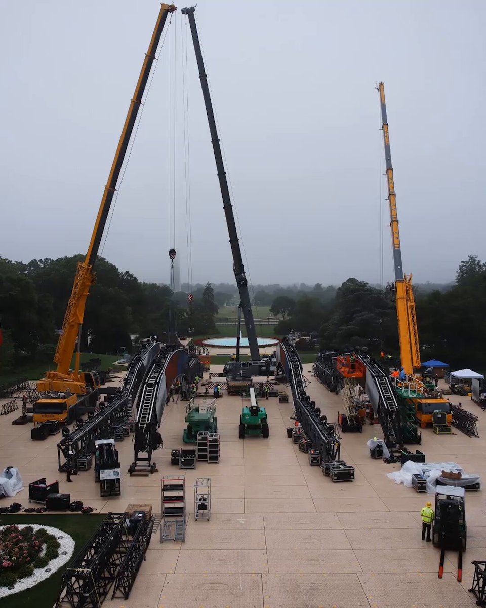 The image shows a large construction site with several cranes, including two tall ones that are yellow and black, as well as smaller ones. The site appears to be bustling with activity, indicating ongoing work or preparation for an event. There are also people present at the site, possibly workers or organizers involved in the project.

The post features a photo of a large white building, which is likely related to the construction taking place on this site. It seems that the image was taken during a specific time period, as indicated by the caption "History in the making #UFCWhiteHouse is LIVE SUNDAY JUNE 14 At 8pmET on @ParamountPlus [ UFC Freedom 250 presented by @CryptoCom and @RamTrucks]".