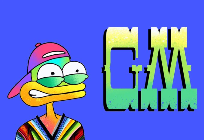 A cartoon frog character wearing a pink backwards cap and tie-dye shirt smiles alongside the gradient "GM" text on a blue background, perfectly complementing the post's "Gm frens" morning greeting.