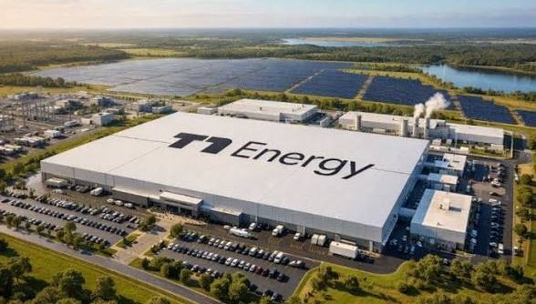 An aerial view of T1 Energy's large-scale manufacturing facility with "T1 Energy" prominently displayed on the rooftop, surrounded by solar panel fields and parking lots full of vehicles.

The image directly relates to the post by showcasing T1 Energy's physical industrial operations and renewable energy infrastructure, visually representing the company behind the convertible notes filing discussed in the accompanying text.