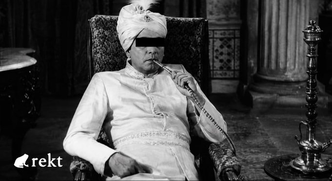 A figure in traditional regal attire smokes a hookah while seated in an ornate chair, with the watermark "rekt" visible in the corner. The image ironically illustrates the post's message about an attacker leisurely exploiting a Cosmos EVM underflow bug on MANTRA Chain to drain $3.6 million in tokens—evoking the image of a sovereign calmly indulging as their treasury is plundered.