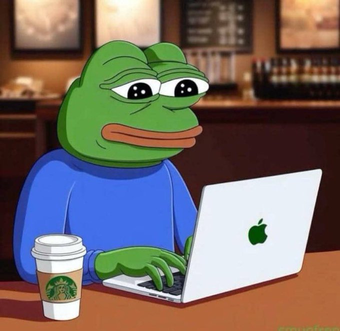 An illustration of the green Pepe the Frog meme sitting at a table, wearing a blue sweater while typing on a silver Apple MacBook, with a Starbucks coffee cup beside him in a café setting.