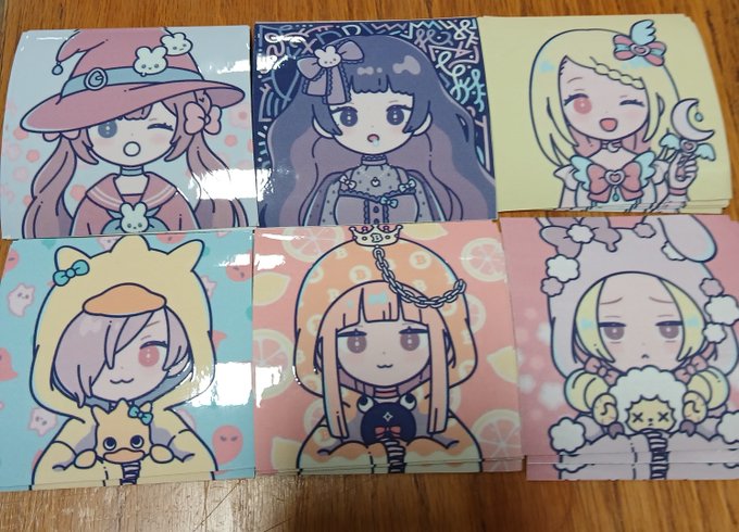 Six square stickers or cards arranged in two rows, each featuring a different pastel-colored chibi-style anime character illustration.