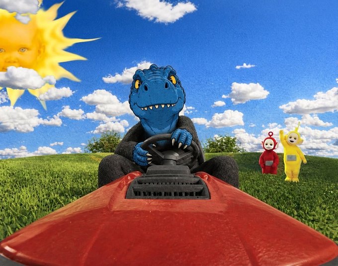 A blue dinosaur character wearing a black suit drives a red vehicle through a grassy field under a blue sky, while Teletubbies characters stand in the background and a sun with a human face watches from the corner.