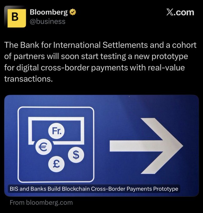 The image features a blue sign that reads "X-COM", which is likely related to a social media platform or website, possibly a Twitter account. The text of the post mentions an interesting project called "HUGE" (Bank for International Settlements) and talks about how it's testing a new prototype for digital cross-border payments with real-value transactions. The image also includes a symbol that resembles a dollar sign, which could be related to the XRP currency or another form of cryptocurrency.