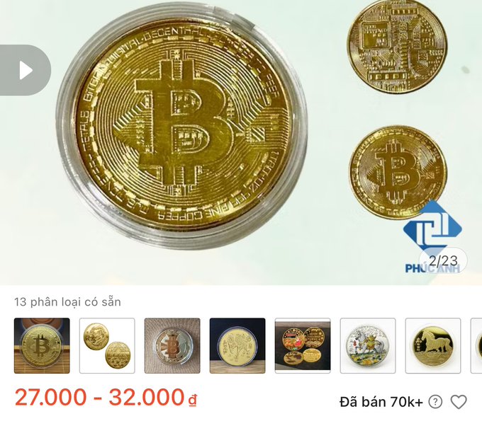 The image shows a Shopee listing for commemorative Bitcoin coins priced at 27,000-32,000 VND, with 13 available styles and over 70k sold, as noted in the caption joking about their realistic appearance as novelty keychains.