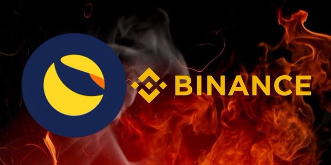 The image features the yellow and dark blue LUNC (Terra Luna Classic) logo next to the yellow Binance logo, set against a dramatic background of orange flames and rising smoke, visually illustrating Binance's burning of LUNC tokens. The fiery backdrop symbolizes the "burning" of LUNC coins, referencing the post's announcement that Binance burned 606,696,111 LUNCs in July as part of its monthly token burn commitment.