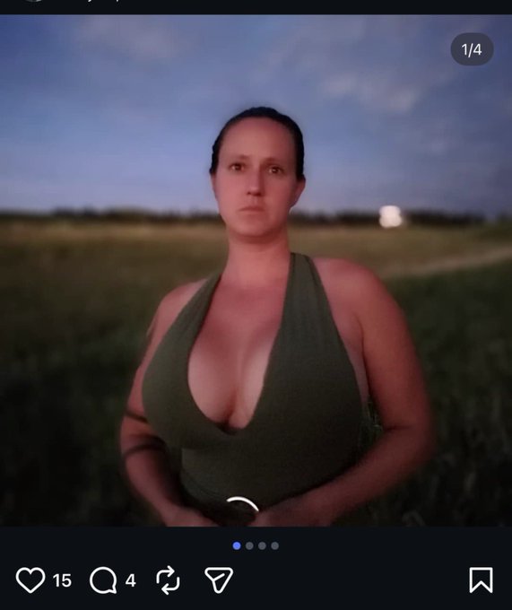 A woman stands in a field at dusk wearing an olive green halter top, with engagement metrics showing 15 likes, 4 comments, and a "1/4" indicator suggesting it's part of a series. The image appears to be the personal photo that the poster's wife had shared on social media, which was then stolen and posted by the trans-identified individual referenced in the accompanying text as part of an online harassment campaign tied to DOGE-related job loss.