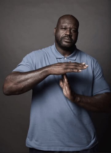 A man in a blue polo shirt holds his hands in a "time out" gesture, symbolizing the frustration of missed opportunities referenced in the caption about Monad falling short of its potential to disrupt the crypto space like Robinhood.