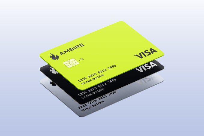 A stack of three Ambire Visa cards in lime green, black, and silver tones, displaying the card number "1234 5678 9012 3456" and the name "VITALIK BUTERIN." The image visually reinforces the post's question about launching a crypto-linked Visa card, particularly one featuring Vitalik Buterin's name.