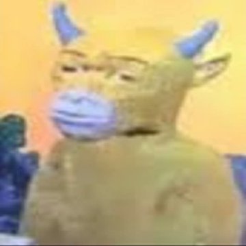 A blurry, low-resolution image of a muscular humanoid figure with horns or pointed ears, wearing a blue surgical face mask, with a person visible in the background.