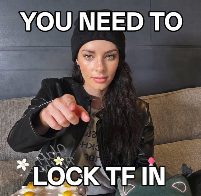 Motivational-style meme featuring a woman in a black beanie and leather jacket pointing at the camera, with overlaid text reading 'YOU NEED TO LOCK TF IN'.