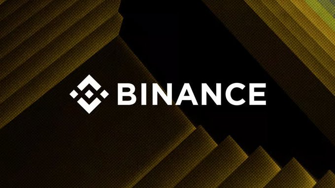 The Binance logo displayed in white on a dark gold and black geometric background.