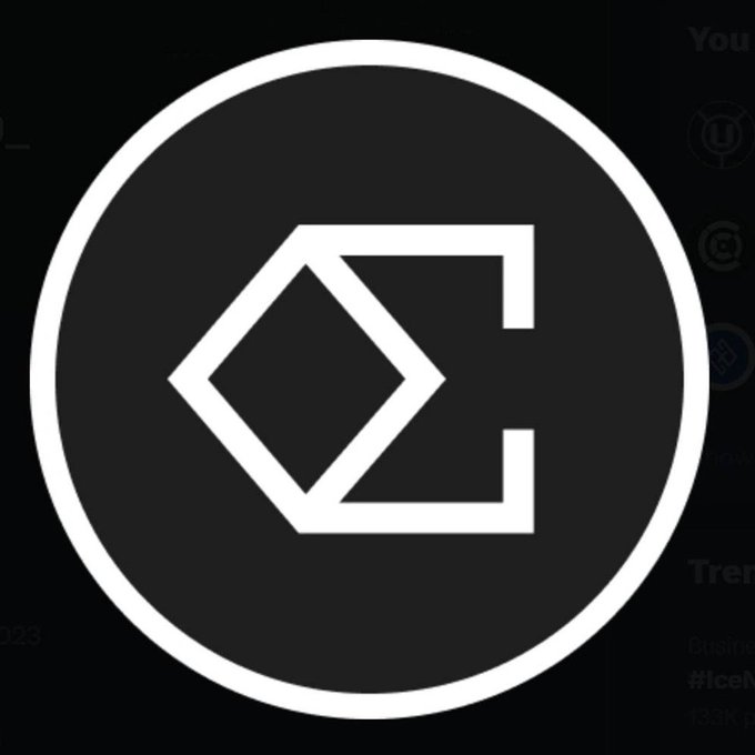 The image displays a circular logo featuring a stylized white diamond shape connected to a square outline, which is the Ethena ($ENA) cryptocurrency logo. This visual relates to the post's announcement of $ENA reaching a new 2026 high following a partnership with Binance.