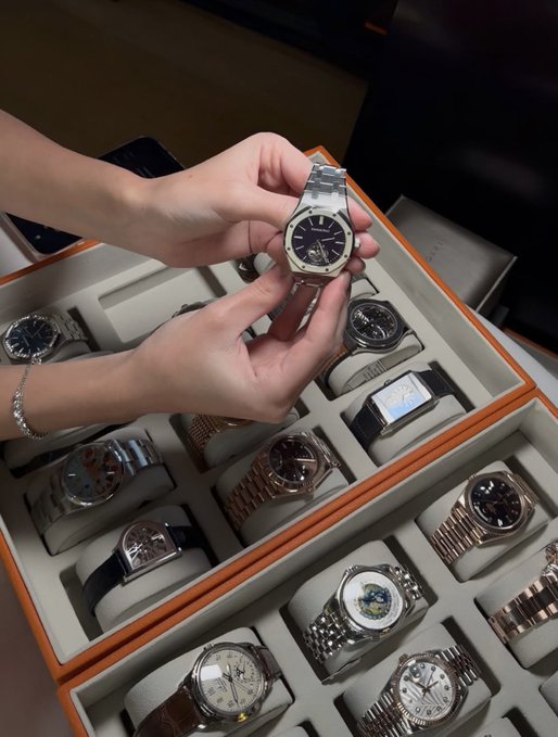 A person holds up an Audemars Piguet Royal Oak watch from a tray of luxury timepieces, seemingly used as a "gm" flex post to celebrate Solana (SOL) trading at $1.20.