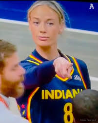 A blurry image shows a blonde-haired athlete wearing an Indiana jersey with the number 8, alongside another person in a sports setting. The image's sports jersey with "INDIANA" and the number 8 serves as a playful visual pun in the context of the post, possibly nodding to NFT collections or team affiliations being discussed by the crypto community.