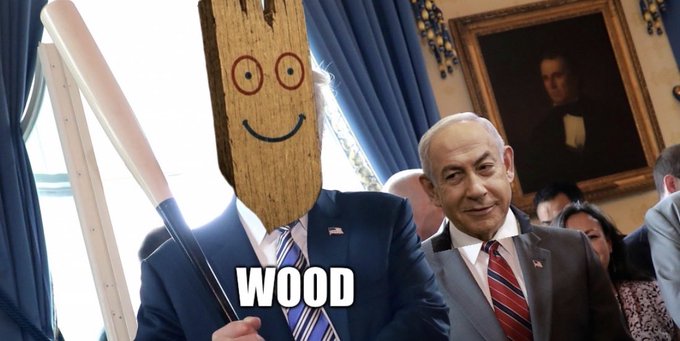A photo with a plank-faced figure in a suit holding a wooden bat, captioned 'WOOD', standing next to Benjamin Netanyahu.