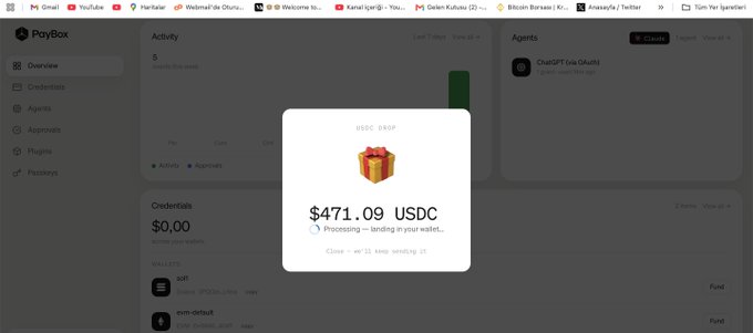Screenshot of a PayBox interface showing a USDC DROP popup for $471.09 USDC processing, with the text 'Processing — landing in your wallet...' and an 'Open' button.