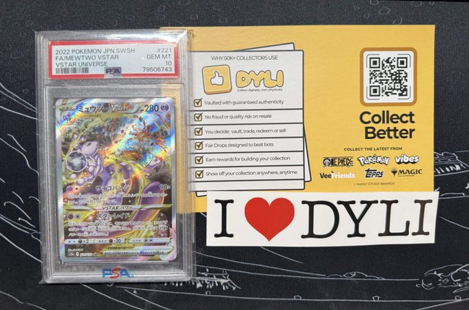 A graded PSA 10 Gem Mint 2022 Pokémon Japanese SWSH 'Fame' Two VSTAR Universe card (#221) sits next to a yellow DYLI promotional card and an 'I ❤️ DYLI' sticker.