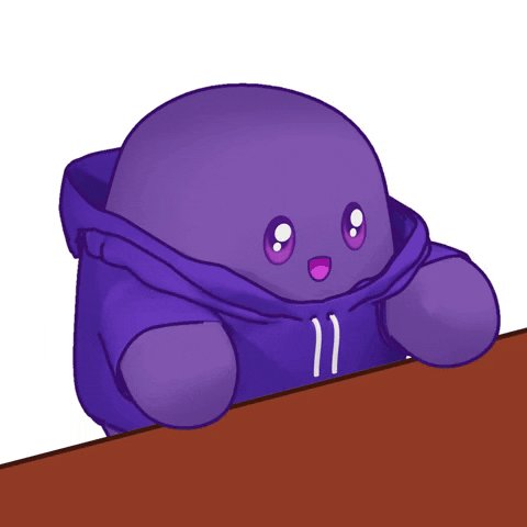 The image features a purple stuffed animal, possibly a teddy bear or a frog, sitting at a desk with its arms and legs spread out. The animal appears to be wearing a blue hoodie, which adds a playful touch to the scene. The background of the image is white, making the colorful figure stand out even more. The caption "WE WANT ‘EM ALL!!" suggests that this image might be related to an advertisement or promotion for a product or service, as it uses a cute and engaging visual to grab attention and convey its message effectively.