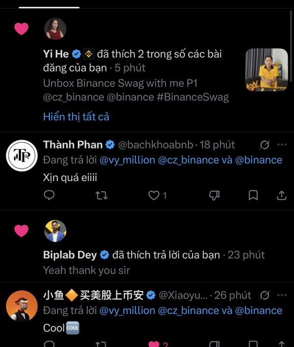 A screenshot of social media replies in Vietnamese, featuring Binance executives Yi He, Biplab Dey, and others commenting on an "Unbox Binance Swag" post.