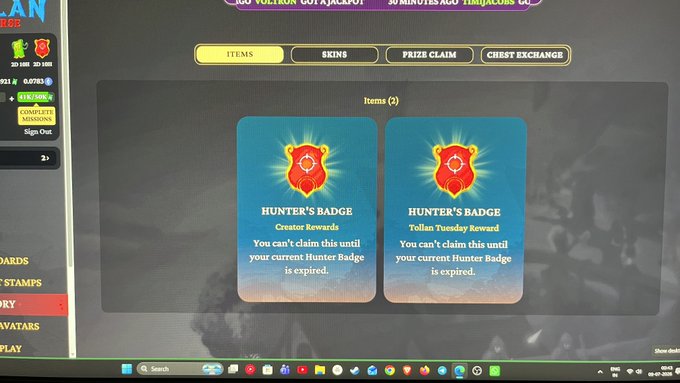 A computer screen displays a game's Hunter's Badge reward system with two cards showing Creator Rewards and Tollan Tuesday Reward, with navigation tabs for Items, Skins, Prize Claim, and Chest Exchange.