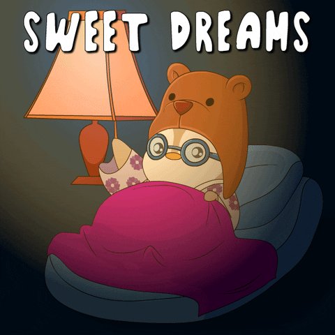 The image features a cartoon penguin wearing a hat with a teddy bear sitting next to it while both are sleeping under a pink blanket. The background of the image is dark, which contrasts with the bright colors of the penguin's outfit and the teddy bear's face. The text "Sweet Dreams" is written in white at the top of the image, and there is also an image of a lamp on the left side of the image.