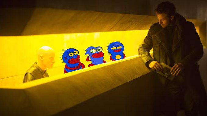 A scene from the movie Blade Runner 2049 showing Officer K standing in a yellow-lit corridor across from a replicant, with three blue fuzzy puppet characters digitally edited into the scene between them.