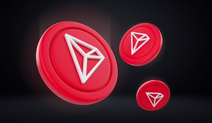 Three red 3D-rendered TRON (TRX) cryptocurrency coins floating against a dark background.