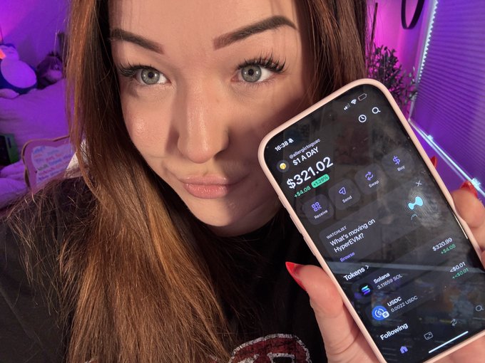 A woman with long brown hair and green eyes holds up a smartphone displaying the Hyperliquid (HYPE) token at $321.02, showing a watchlist and trending tokens including Solana and USDC.