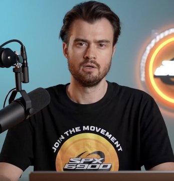 A man with a beard speaks into a professional microphone while wearing a black "JOIN THE MOVEMENT" t-shirt featuring the SPX6900 logo with a cloud graphic. The image accompanies Murad's bold prediction that the SPX6900 cryptocurrency will overtake the SPX500.