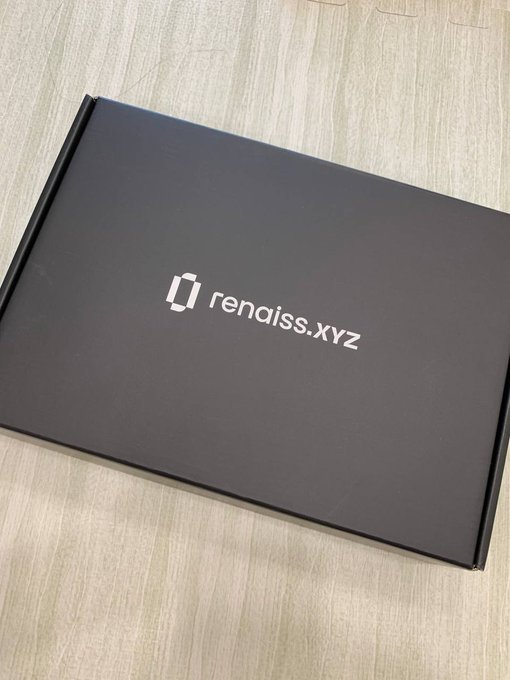 A black box with the logo 'rendiss.xyz' printed on its lid, resting on a wooden surface.