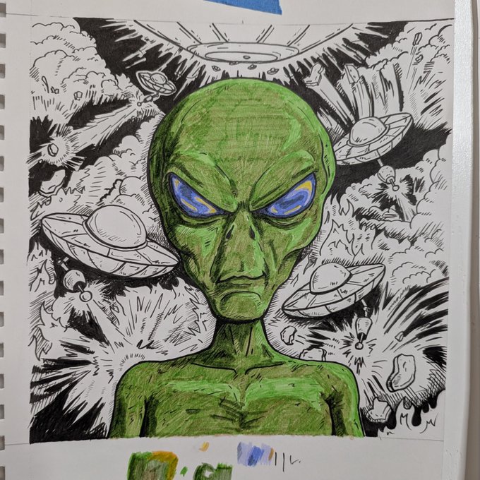 A hand-drawn sketch in a spiral notebook depicts a green alien with striking blue eyes, surrounded by numerous black-and-white UFOs bursting through clouds, with a large saucer hovering overhead. The accompanying text reflects on the artist's plan to digitize and color-separate this analog piece for an on-chain transformation, mirroring the artwork's blend of physical ink work and the digital realm it will enter.