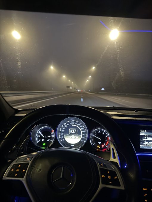 A view from the driver's seat of a Mercedes-Benz driving through a foggy tunnel at night, with the speedometer showing 171 km/h.