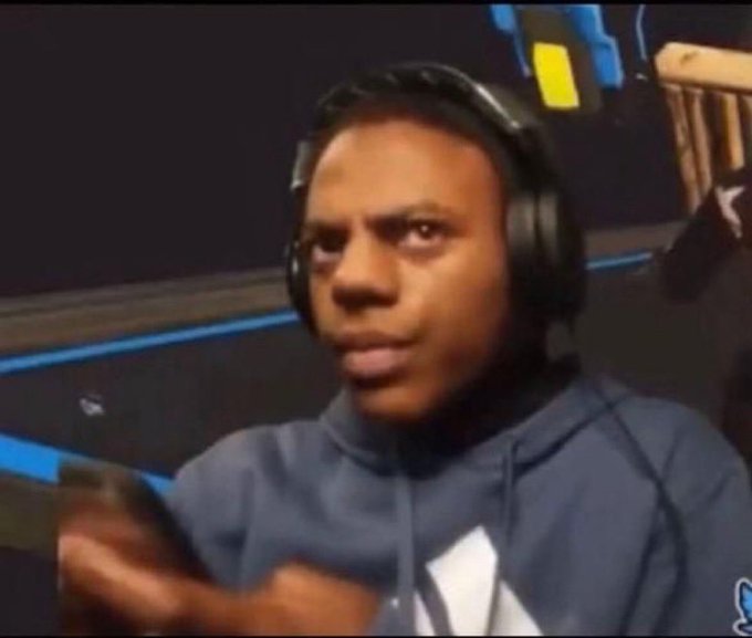 A young man wearing a dark hoodie and large over-ear headphones sits in what appears to be a streaming or gaming setup, looking directly at the camera with a surprised and somewhat bewildered expression, with his hand slightly raised—visually echoing the post's "Wow" reaction to learning that everyone uses Bitget, the cryptocurrency exchange.