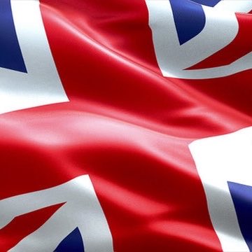 A close-up of the United Kingdom's Union Jack flag waving in the wind.