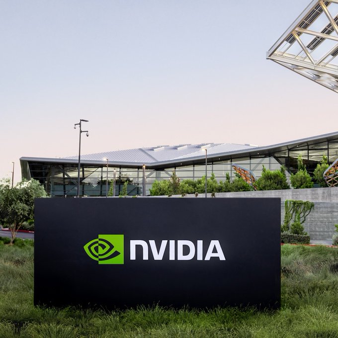 An NVIDIA company sign with the iconic green logo displayed in front of their modern corporate building.