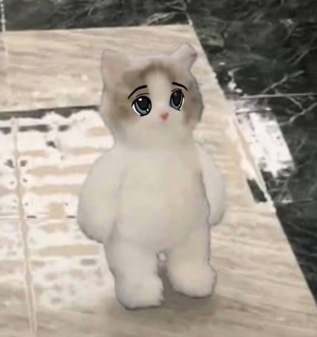 A small white and brown plush cat with anime-style large expressive eyes standing on a marble floor.