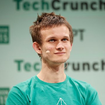 The image shows Vitalik Buterin, Ethereum's co-founder, wearing a green shirt and headset microphone at a TechCrunch event. The caption relates to his recent statement that pseudonymity is becoming obsolete as AI advances make it easier to connect identities through digital behavior patterns.