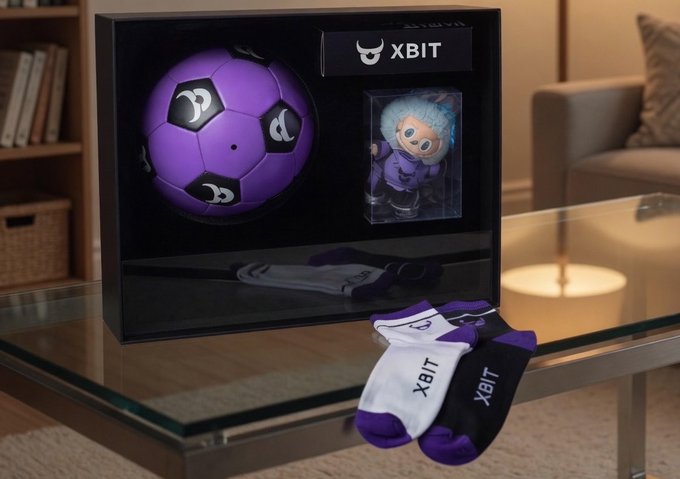 The image features a black glass coffee table with various items placed on top of it, including two pairs of socks - one purple and one white. A soccer ball is also present on the table. The objects are arranged in such a way that they create an interesting visual display, possibly related to a post about XBITDEX or soccer balls.