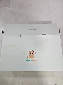 The image shows a white cardboard box with a cartoon character design on it that says "Atour" written in green letters. The box has two handles on its sides, suggesting it's designed for easy transport or storage. The text "@bitdeer" is also present in the image, which could indicate that the box contains items related to Atour or is a product from @bitdeer.