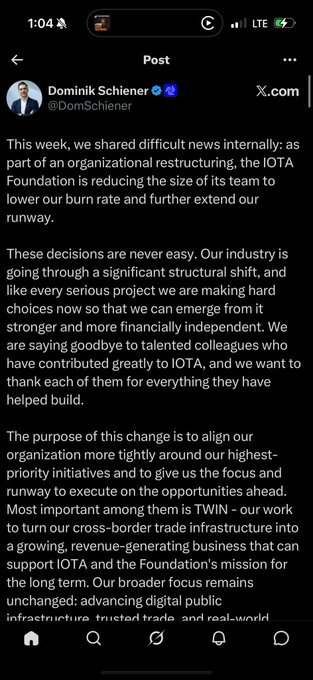 A screenshot of a post on X.com by Dominik Schiener (@DomSchiener) from the IOTA Foundation discussing organizational restructuring and team reductions to extend their runway.
