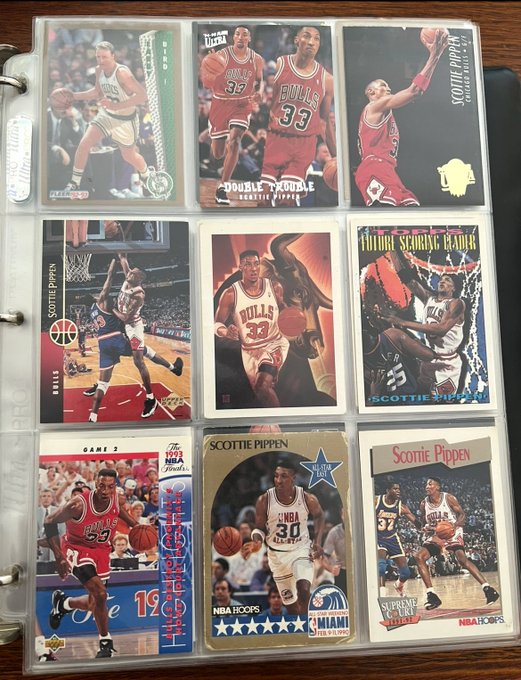 A collection of Scottie Pippen basketball trading cards in protective sleeves, including Ultra, Fleer Ultra, and NBA Hoops editions featuring his Chicago Bulls playing days.