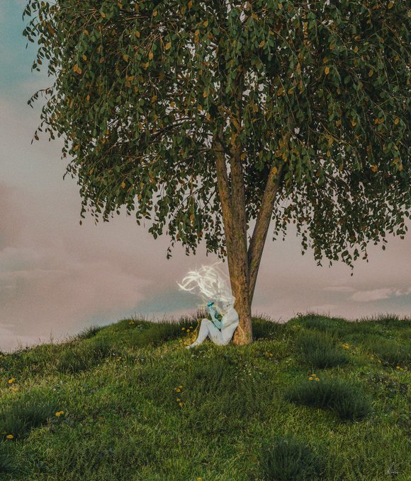 A surreal, dreamy photo of a pale figure with flowing white hair sitting at the base of a large tree on a grassy hill dotted with small yellow flowers, under a soft pink and blue sky.