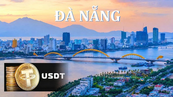 A scenic view of Đà Nẵng, Vietnam, showing a bridge and city skyline at sunset, with a graphic overlay of stacked coins and the "USDT" logo.