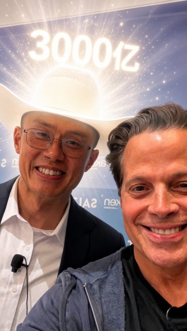 A selfie of two men smiling in front of a backdrop displaying '30000亿' (300 billion) and the 'nex' logo, suggesting an event celebration.
