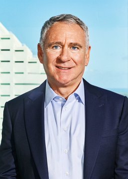 A professional headshot of a smiling man with graying hair in a dark suit and light blue shirt, likely a stock image of a corporate executive or financial figure, used to represent Citadel's acquisition of Leopold Aschenbrenner's AI-affiliated stock portfolio.